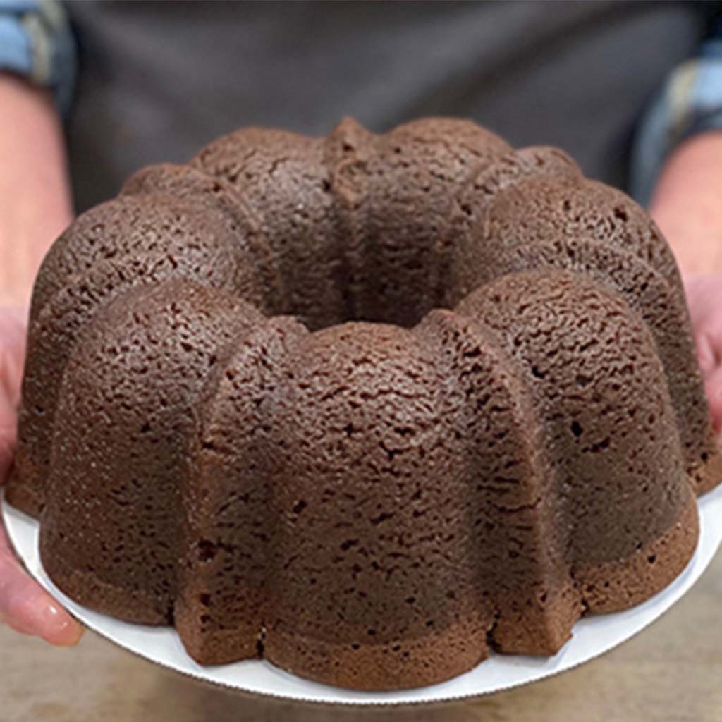 Chocolate TX Bourbon Whiskey Lane Jane pound cake in the shape of a bundt finished off with a whiskey glaze. Serves 12. Packaged in our signature yellow and white striped gift box with a blue bow.