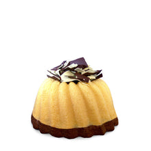 Load image into Gallery viewer, A slice of marbled vanilla and chocolate pound cake in the shape of a bundt filled with chocolate sauce and topped with dark and white chocolate shavings. Serves 6. Packaged in our signature yellow and white striped gift box with a blue bow.