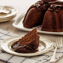 Load image into Gallery viewer, Slice of Chocolate pound cake in the shape of a bundt filled with chocolate sauce and topped with chocolate shavings. Serves 12.