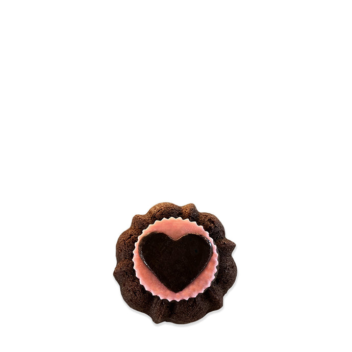 chocolate valentine pound cake in the shaped of a bundt cake topped with a pink chocolate medallion and a chocolate heart for Valentines.