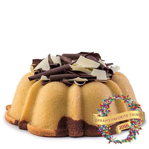 Marbled vanilla and chocolate pound cake in the shape of a bundt filled with chocolate sauce and topped with dark and white chocolate shavings. Serves 12. Oprah's Favorite Things 2016. Packaged in our signature yellow and white striped gift box with a blue bow.