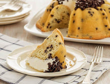 Load image into Gallery viewer, A slice of chocolate chip pound in the shape of a bundt filled with vanilla buttercream and topped with chocolate chips. Serves 12. Oprah&#39;s Favorite Things. Packaged in our signature yellow and white striped gift box with a blue bow.