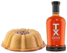 Load image into Gallery viewer, Vanilla pound cake in the shape of a bundt infused with TX Bourbon filled with whiskey toasted pecans and topped with a whiskey glaze. Serves 12. Packaged in our signature yellow and white striped gift box with a blue bow. 